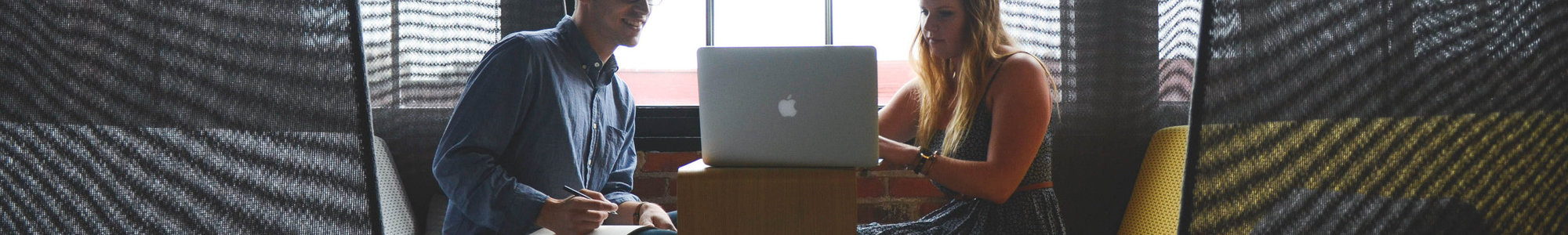 Rsz Canva   Smiling Man And Woman Both Sitting On Sofa Both Looking At Silver Macbook